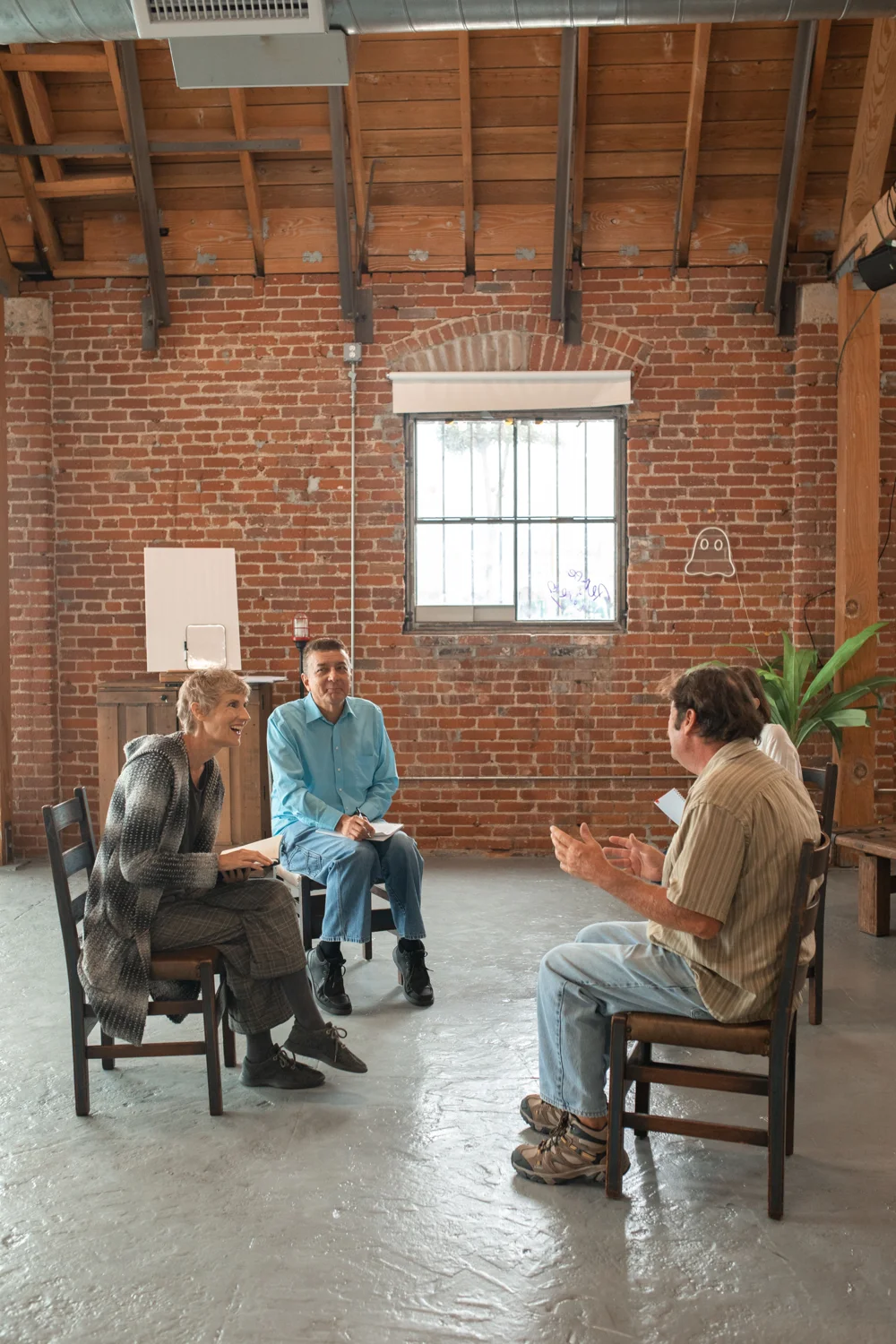 Adults taking part in a guided group discussion. · Illustrative stock photo